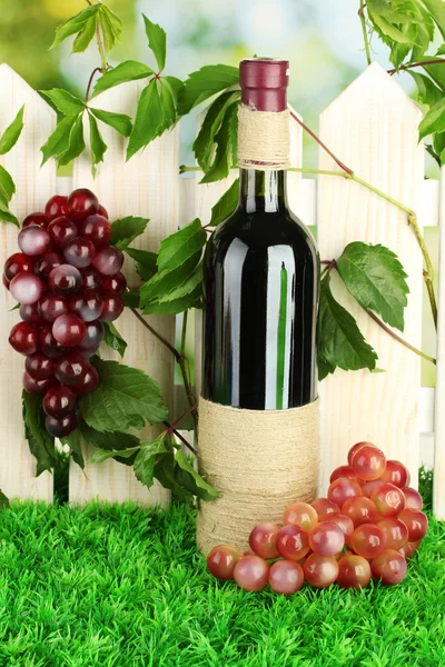 A bottle of wine on the fence background close-up — Stock Photo, Image