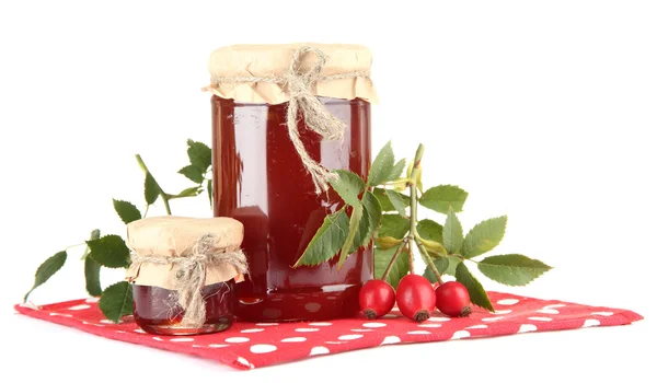 Jars with hip roses jam and ripe berries, isolated on white — Stock Photo, Image