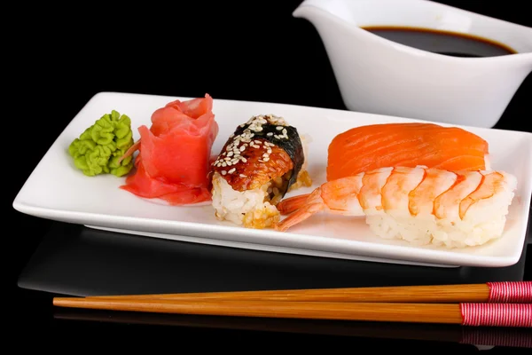 Delicious sushi served on plate isolated on black — Stock Photo, Image