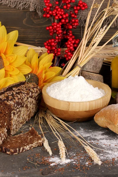 Rye bread on wooden table on wooden background — Stock Photo, Image