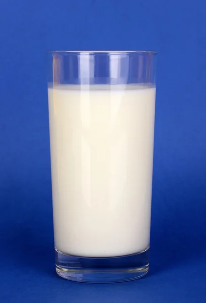 Glass of fresh new milk on blue background — Stock Photo, Image