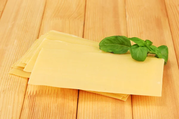 Uncooked lasagna pasta on wooden background — Stock Photo, Image