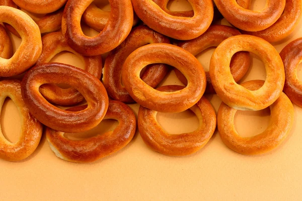 Tasty bagels, on beige background — Stock Photo, Image