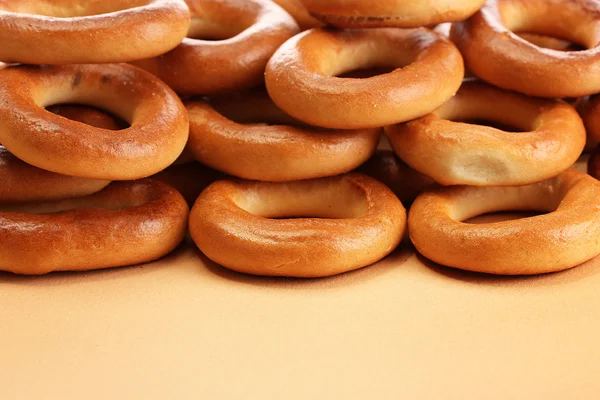 Tasty bagels, on beige background — Stock Photo, Image
