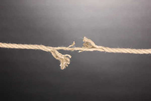 Breaking rope on grey background Stock Photo