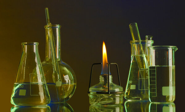 spiritlamp and test-tubes on blue-yellow background