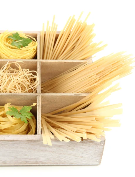 Nine types of pasta in wooden box sections close-up isolated on white — Stock Photo, Image