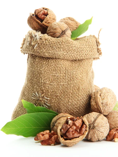 Walnuts with green leaves in burlap bag, isolated on white — Stock Photo, Image