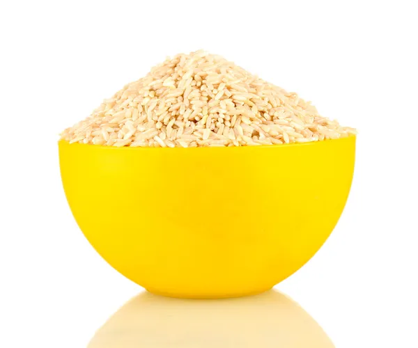 Brown rice in a yellow plate , isolated on white — Stock Photo, Image