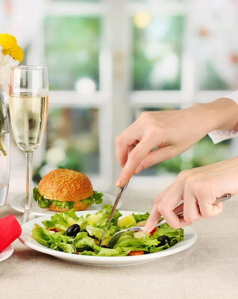 Female hand with dinner on bright background — Stock Photo, Image