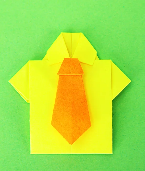 Origami shirt on green background — Stock Photo, Image