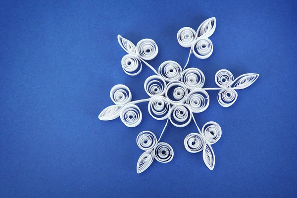 Beautiful paper snowflake, on blue background — Stock Photo, Image