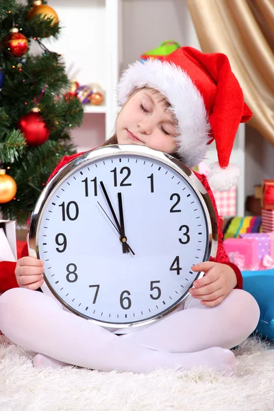 Beautiful little girl sleep in anticipation of New Year in festively decorated room Stock Photo