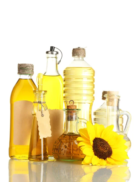 Oil in jars and sunflower, isolated on white — Stock Photo, Image