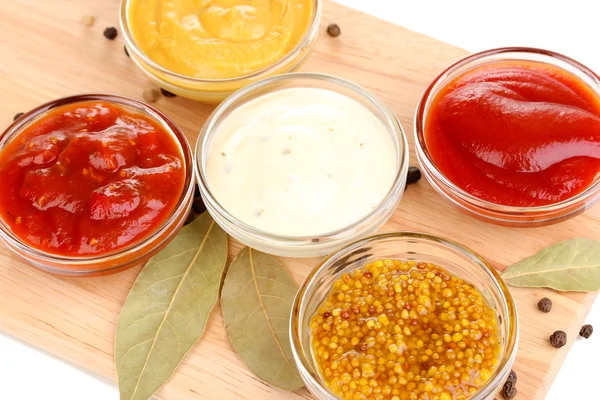 Various sauces on chopping board close-up — Stock Photo, Image