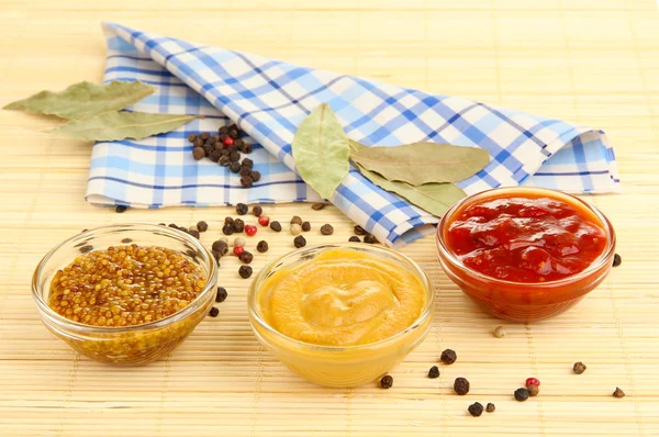 Various sauces on bamboo mat — Stock Photo, Image