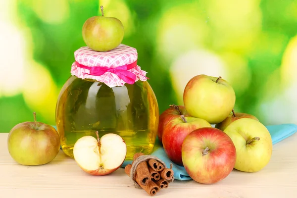 Honey and apples with cinnamon on wooden table on natural background — Stock Photo, Image