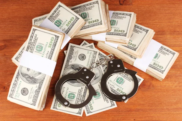 Idea of punishment for financial fraud, on wooden background — Stock Photo, Image