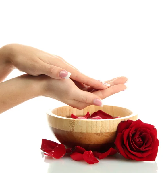 Woman hands with wooden bowl of water with petals, isolated on white — Stock Photo, Image