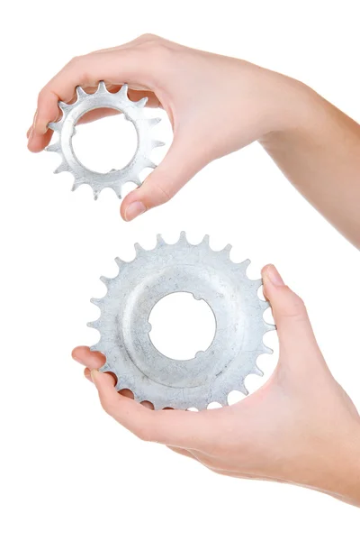 Man holding a pair of old metallic cogwheels in his hands — Stock Photo, Image