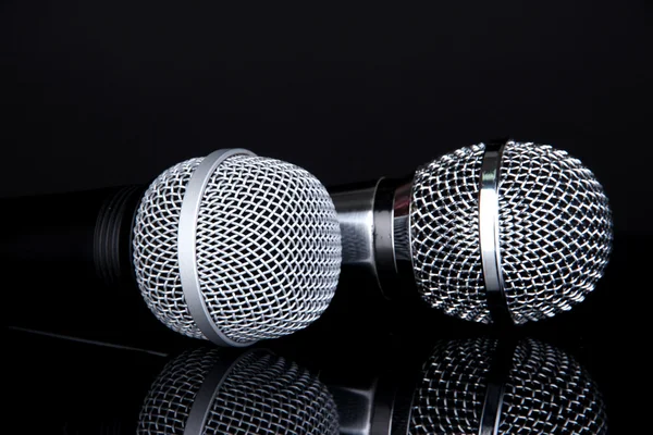 Silver and black microphones isolated on black — Stock Photo, Image