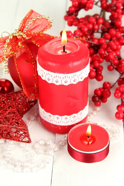 Red candle with christmas decoration on light background — Stock Photo, Image