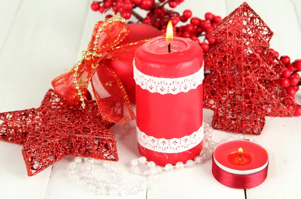 Red candle with christmas decoration on light background — Stock Photo, Image