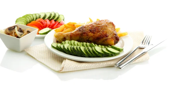Roast chicken with french fries and sliced vegetables on plates, isolated on white — Stock Photo, Image
