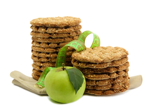 Tasty crispbread, apple and measuring tape, isolated on white — Stock Photo, Image
