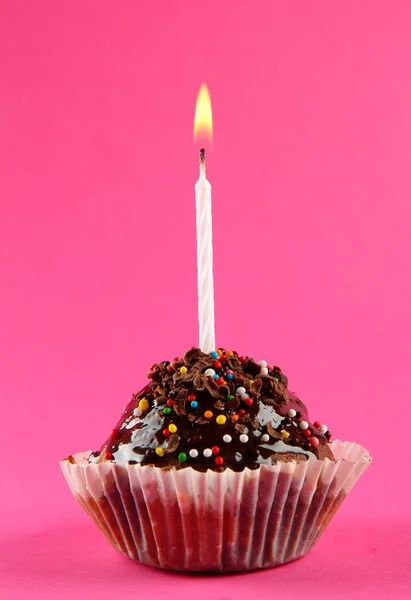 Tasty birthday cupcake with candle, on pink background — Stock Photo, Image