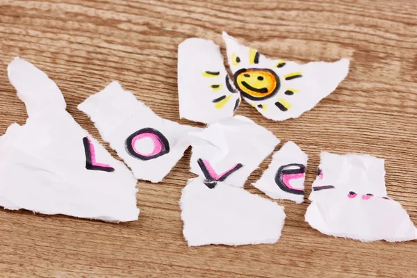 Torn paper with words Love close-up on wooden table — Stock Photo, Image