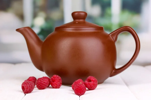 Tea with raspberries on table on bright background — Stock Photo, Image