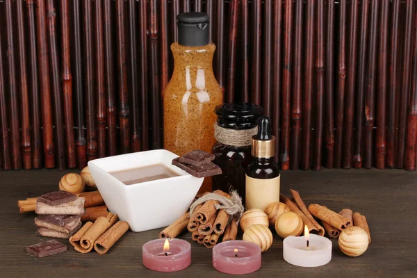 Beautiful chocolate spa setting on wooden table bamboo background with reflection — Stock Photo, Image