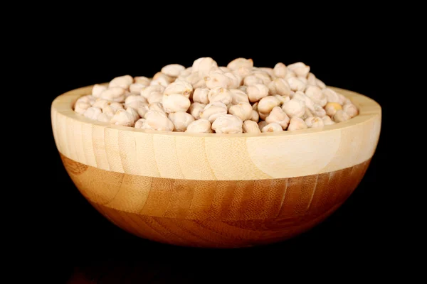White chickpeas in wooden bowl isolated on black — Stock Photo, Image