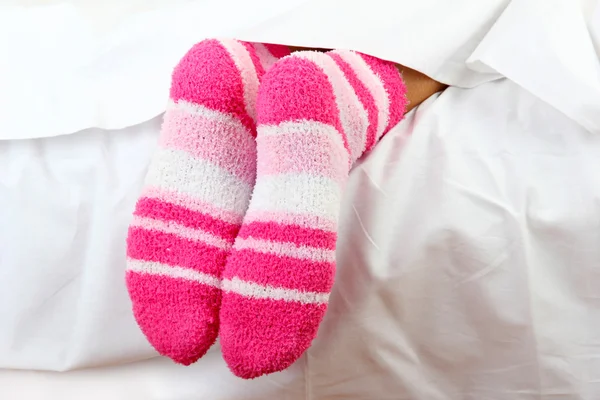 Feet peeking out from blanket — Stock Photo, Image