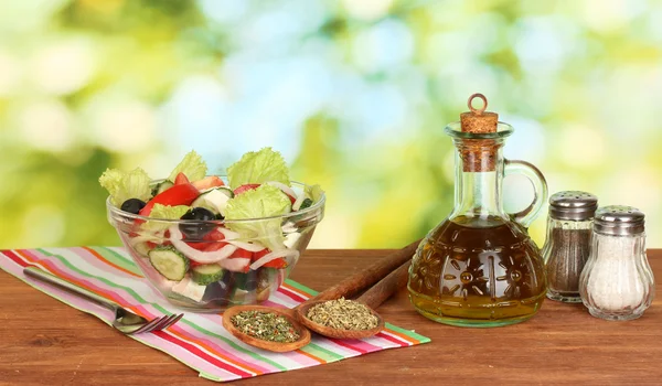 Tasty greek salad on bright green background — Stock Photo, Image