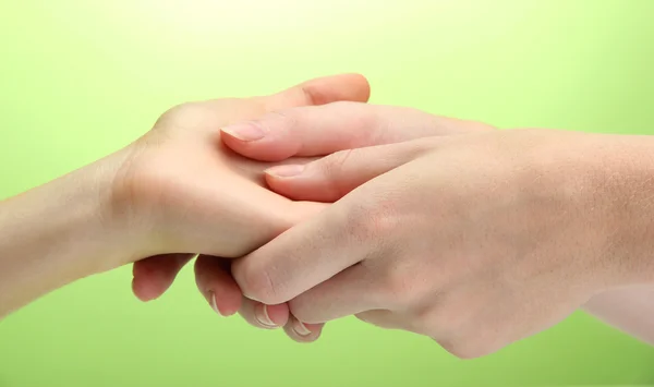 Hand massage, on green background — Stock Photo, Image