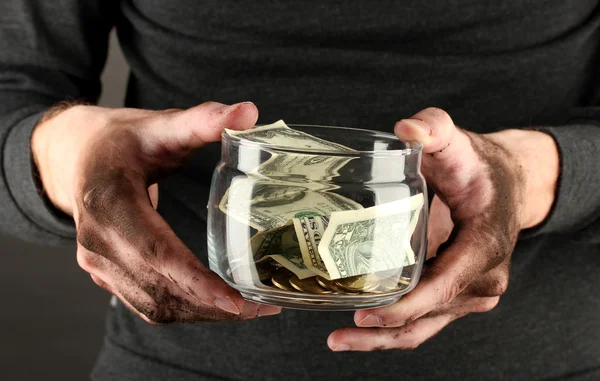 Homeless holds bank with money, close-up — Stock Photo, Image