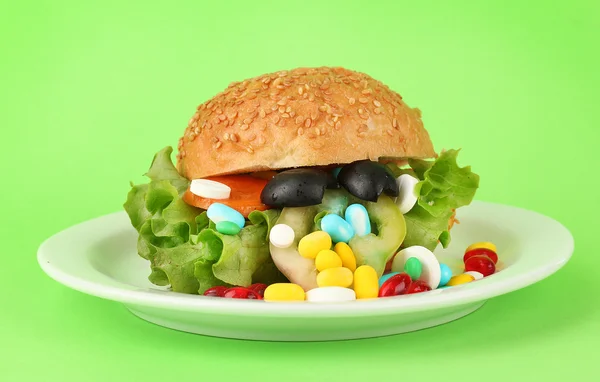 Conceptual image for nutritional care:assorted vitamins and nutritional supplements in bun.On color background — Stock Photo, Image