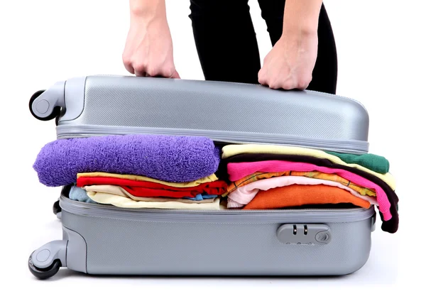 Girl tries to close the suitcase isolated on white — Stock Photo, Image