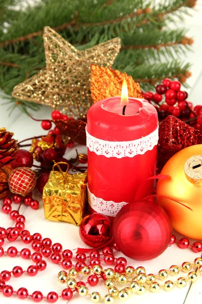 Red candle with christmas decoration on light background — Stock Photo, Image