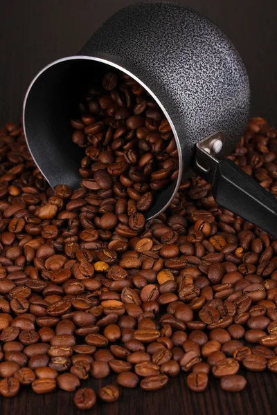 Coffee beans poured from turk — Stock Photo, Image