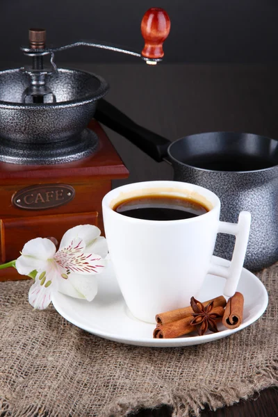 White cup of Turkish coffee with coffee maker and coffee mill on wooden table — Stock Photo, Image