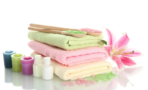 Towels with lily, aroma oil, candles and sea salt isolated on white — Stock Photo, Image