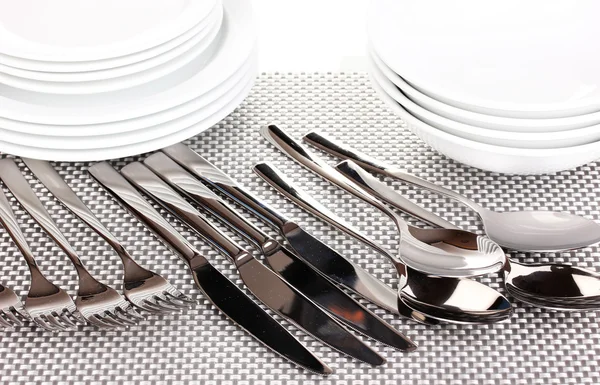 Forks, knifes and spoons on red mat close-up — Stock Photo, Image