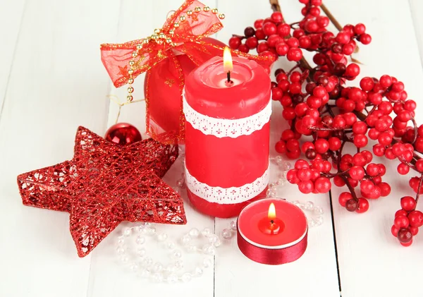Red candle with christmas decoration on light background — Stock Photo, Image