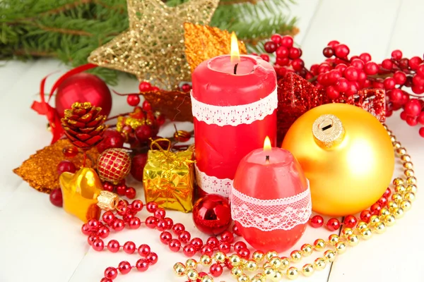 Red candle with christmas decoration on light background — Stock Photo, Image