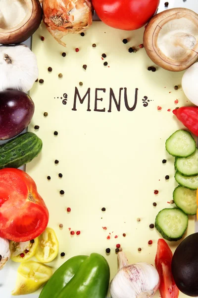 Menu cercado por produtos e legumes em papel amarelo — Fotografia de Stock