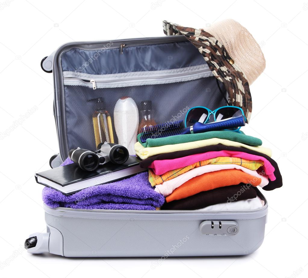 Open silver suitcase with clothing isolated on white