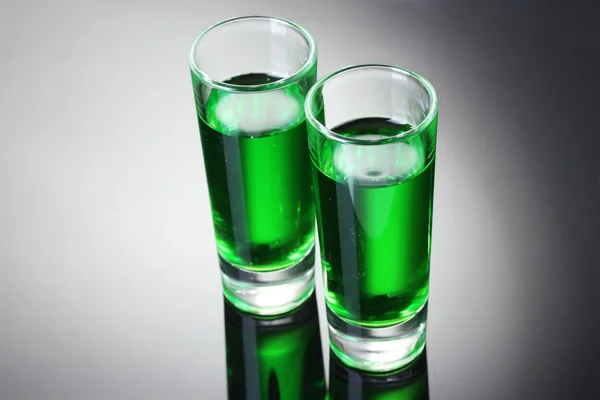 Two glasses of absinthe on grey background — Stock Photo, Image